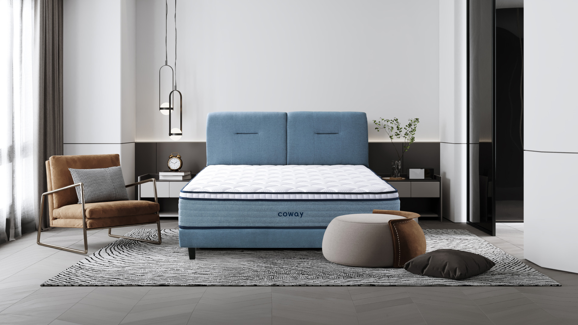 coway-prime-lite-series-mattress-at-the-center-of-the-room-with-an-armchair-and-a-footrest-with-a-pillow-on-the-floor